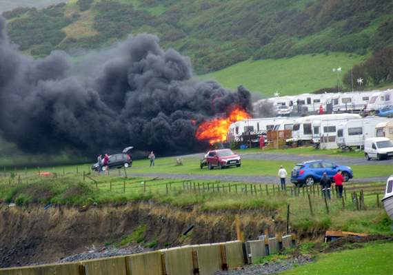 Flames and smoke billow from the caravan