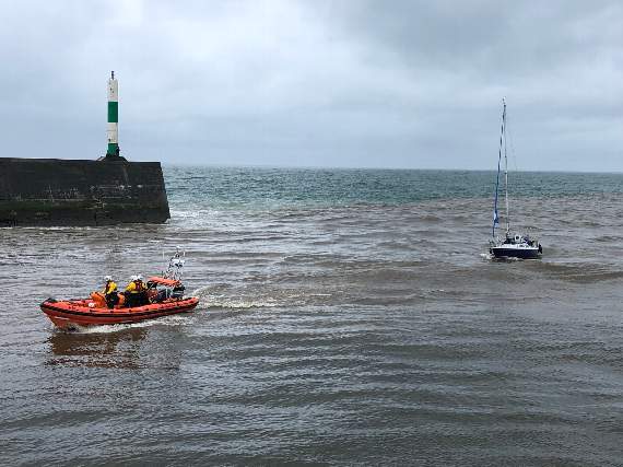 Aberystwyth lifeboat towing the yacht into harbour