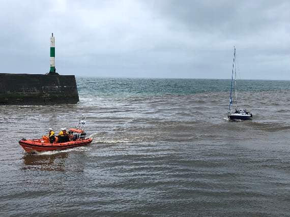 Aberystwyth lifeboat towing the yacht into harbour