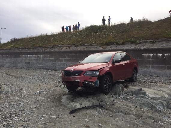 The car which rolled out of a driveway, across a road, down a bank and onto the beach, luckily injuring no-one in the process Picture by Looe Coastguard
