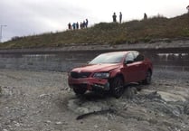 Lucky escape as car rolls onto rocks