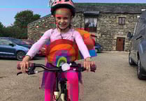 Liliana 'zooms off' on her bike to raise hundreds for Foodbank
