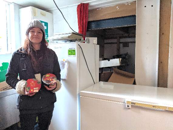 Sam Constance next to the community fridge and freezer at Community Treasure Chest in Liskeard