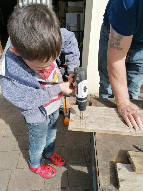 Henry constructing the bug hotel with his dad Adrian. His brothers Alfie and William helped too.
