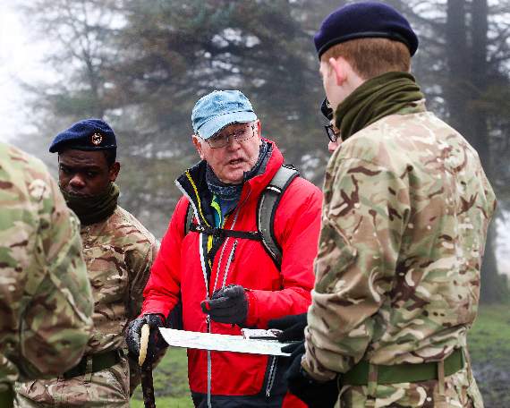 Naval Veteran Les Yeoman helping a group of recruits with their navigation on Dartmoor.