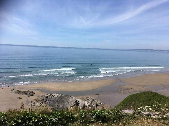 A rip current at Tregonhawke in Whitsand Bay. The rip is indicated by the area of calmer water visible between the breaking waves
