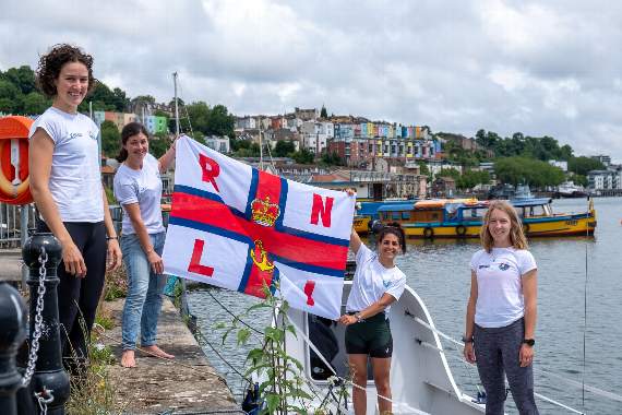 The team with their Eco Boat and RNLI flag in Bristol Harbour