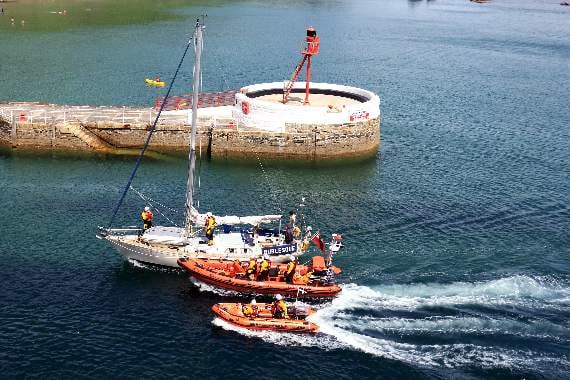 The two Looe lifeboats coming into harbour with the casualty yacht