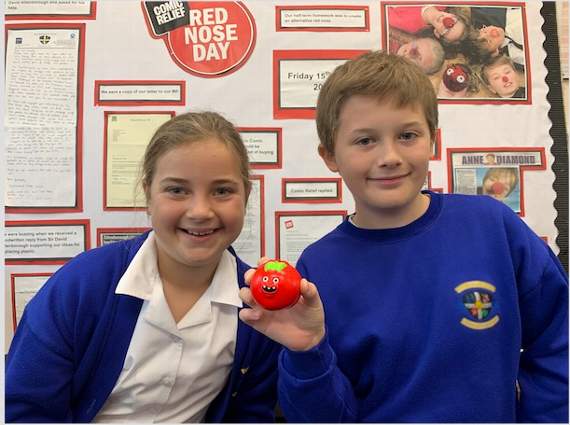 Fourlanesend Community School pupils with one of the new environmentally-friendly red noses made of sustainable bagasse. Picture courtesy of 2020 Comic Relief