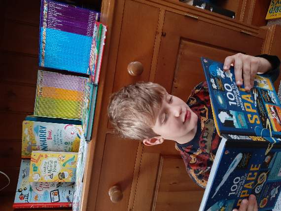 A book pledge has been launched and Liskeard mum Kelly Nokes hopes to see £1000 worth of books go out to families in Foodbank parcels. Pictured is Kelly's son Jenson, seven
