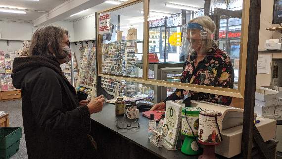 Debbie serves customer Anne Marr, who loves the store's range of supplements and oils