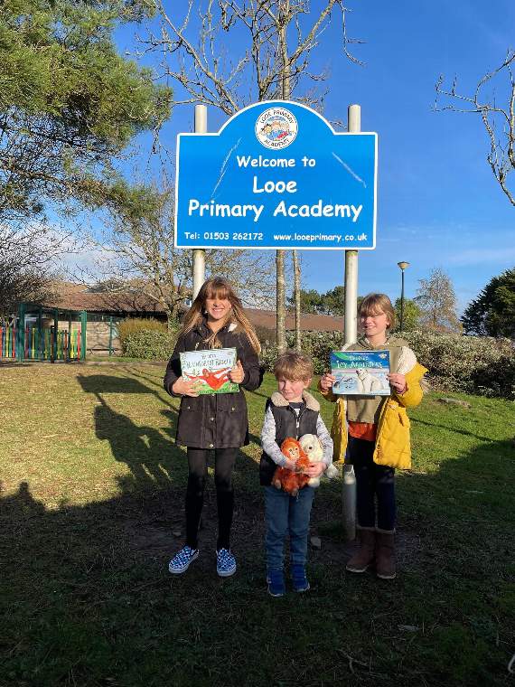 Isobel Crabb (11), Phoebe Crabb (9) and Charlie Crabb (3) dropping some of the new books off to Looe Primary School kindly donated by The Crabb Pot, Looe.