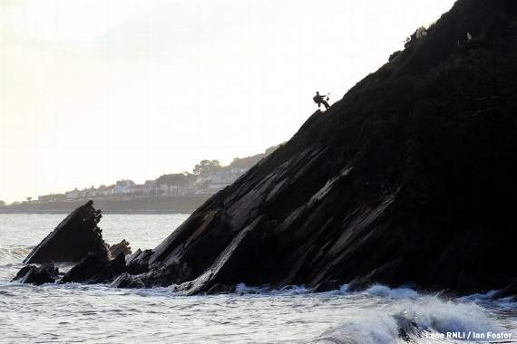 A Looe Coastguard rope rescue technician approaching the casualties. Photo Looe RNLI / Ian Foster