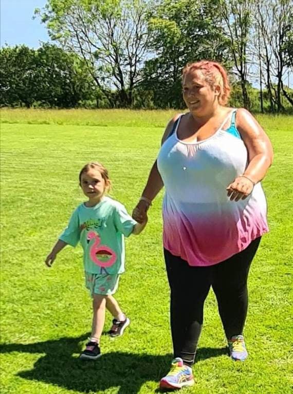 Kora and mum Xana Bradley doing a lap of the field
