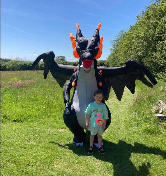 Kora's dad Tom braved the heat to dress up as his daughter's favourite black dragon anime character