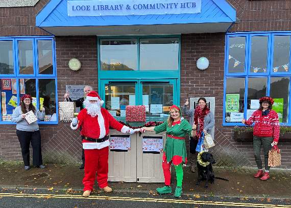 Santa with Cllr Edwina Hannaford and his other helpers in Looe to launch the festive initiative
