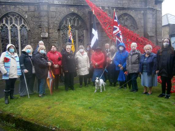 Callington Portreeve Suzan Tolman, standard bearers and knitting volunteers in front of the poppy wave outside the parish church. Picture: Simon Artymiuk