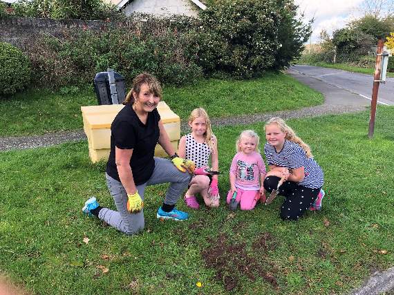 CHILDREN from Carey Park, Polperro with Councillor Edwina Hannaford when they helped to tidy up and plant bulbs at the entrance to the estate last year