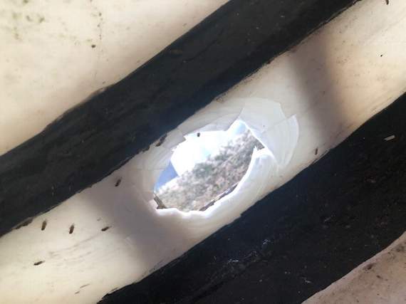 The hole in the clock face that may have been caused by an air rifle