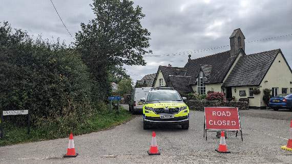 A police cordon is in place near the scene of the fire which has caused severe damage to a house in Deviock, near Seaton. A 20-year-old man remains unaccounted for since Sunday