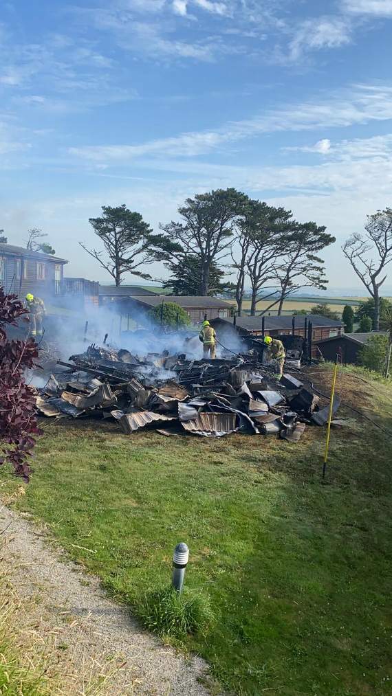 Fire crew attending to the remnants of the destroyed chalet