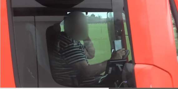 Footage showing an HGV driver on the M4 using two phones