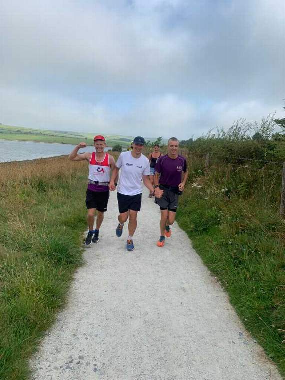The three friends coming in at the end of the 100 miles in 22 hours 36 minutes