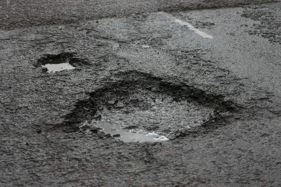 One of the potholes on the road from Thorn Hedges Cross to East Lodge, Long Barn, Sandford.  AQ 0951