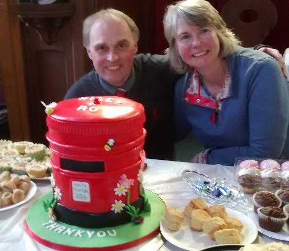 Nigel and Rosemary Davies with the celebration cake in the form of a pillar box.