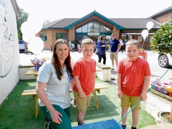 Veterinary nurse, Alex-Louise Bache with twins Charlie and Freddie Jordon (8) winning prizes at Hook-a-Duck during the opening of the new branch of Jonathan Wood Veterinary Surgery at Bernaville Nurseries. NP 300516 01