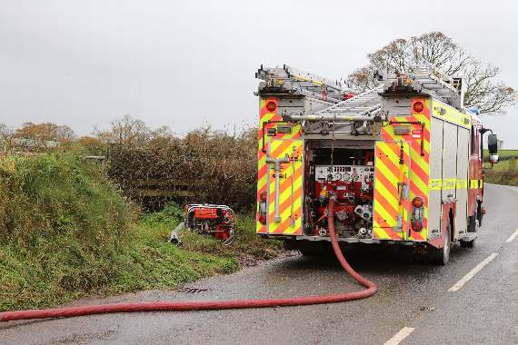 One of the fire appliances on the A3072 near the scene of the fire which destroyed The Old Rectory at Clannaborough. AQ 5379