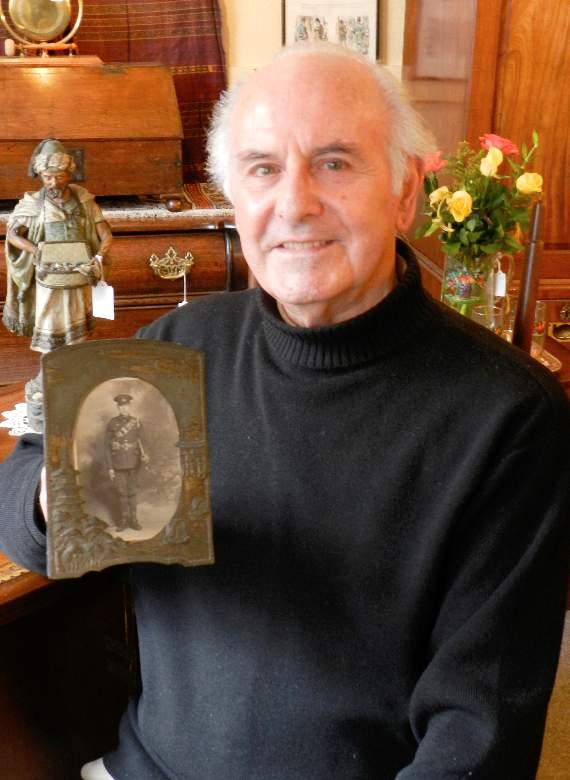 James Lock of James Antiques with the photograph of his father Faithful Lock, who fought in World War One.