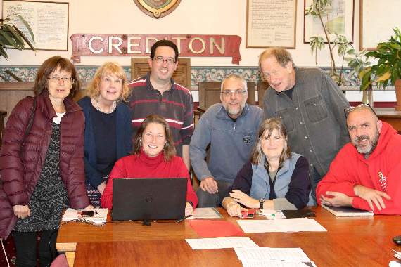 Members of Crediton’s Christmas in Crediton committee, standing, from left, Rosemary Stephenson, Cllr Anne Hughes, Andi Wyer, David Oliver and Peter Hamilton and seated right, Andrew Drayton with, seated, centre, committee chairman Cllr Elizabeth Brookes-Hocking and seated left, Clare Dalley, Crediton Town Clerk, the event manager. AQ 5540