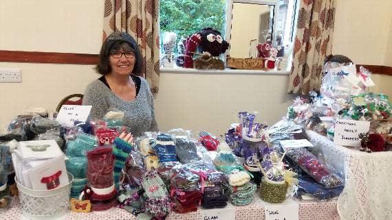 Lesley Rogers with some of the hand-knitted Christmas gifts she made, for sale at the last Cheriton Fitzpaine Monthly Market.