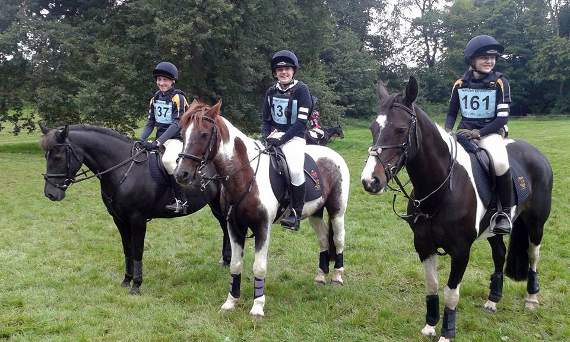 The QE School Equestrian team members, Jamie Crang, Holly Burrows and Alice Turner, and their ponies.