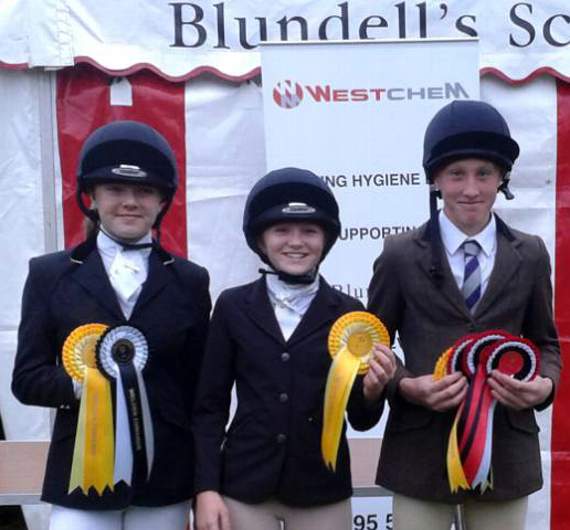 The QE team members, Holly Burrows, Alice Turner and Jamie Crang with their rosettes after the competition.