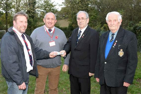 Simon Thompson, left, and James Chapman, joint club captains, Ide Barbarians RFC, present the donation of £250 to David Blake, chairman, Alphington branch Royal British Legion, third left, with right, John Blake (David Blake’s father), president, Alphington branch RBL. AQ 5311