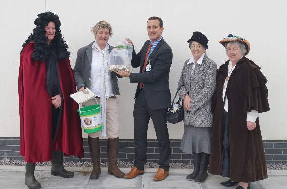 The money being presented by Chulmleigh Community College to the Chulmleigh Friends of Children’s Hospice South West group.