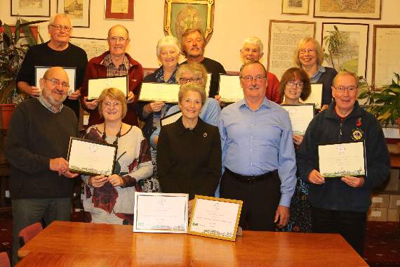 Silver Gilt Award in the RHS Britain In Bloom SW competition is Lynette Talbot, RHS Judge and Chair of Sidmouth In Bloom, centre, front, which was received by Crediton Town Councillor Michael Szabo, Chairman of the Floral Crediton committee. A total of 14 Crediton voluntary community groups entered into the It’s Your Neighbourhood (IYN) Britain In Bloom South West competition and representatives from these groups, some of which are pictured, were also presented with awards. AQ 5229
