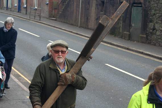 John Musty carrying the cross along Crediton High Street. SR 8965