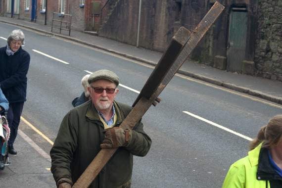 John Musty carrying the cross along Crediton High Street. SR 8965