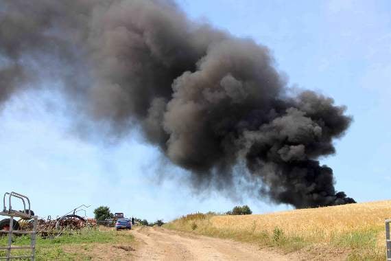 Black smoke rising from the fire involving a silage pit and tyres at Sandford Ash, New Buildings. AQ 2515