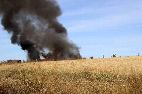 Firefighters tackling the fire at Sandford Ash, New Buildings, near Crediton. AQ 2524