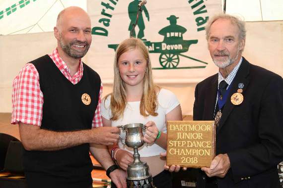 BBC South West weather presenter Dan Downs, left and the Deputy Mayor of West Devon, Cllr Tony Leech, presenting Ruth Frangleton with the Junior Dartmoor Step Dance trophy. AQ 4688