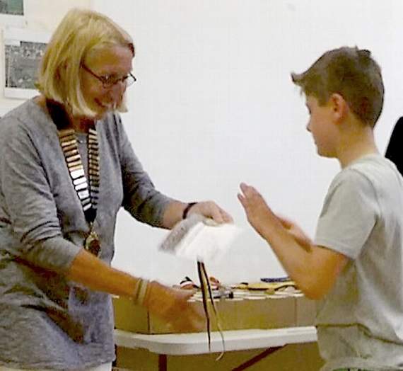 Crediton’s Freddie Heard, from Exeter Canoe Club, receives his winners medal from the Chair of Calstock Parish Council.
