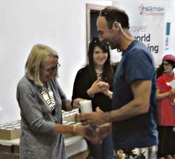 Jamie Piper receives his medal for coming third in the Elite Division Three Race from the Chair of Calstock Parish Council.