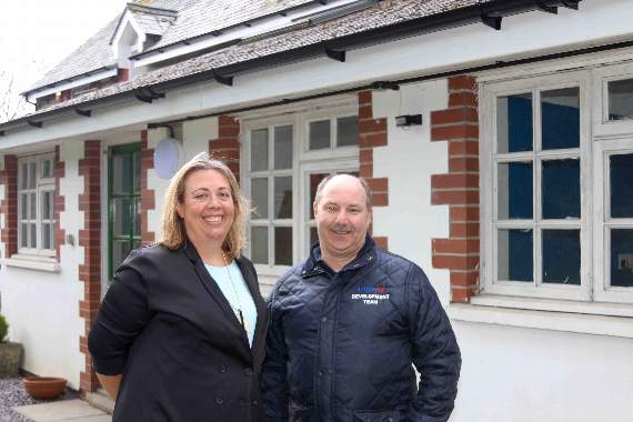 Caroline Welsh, Director of Brand and Marketing and Paul Baker, programme manager, both from Screwfix, in front of the new lighting and fascia boards installed at Ashley Court, Chawleigh. AQ 0177