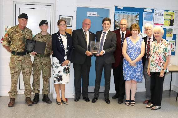 Tom Mann (18), centre was presented with the 2018 Jamie Fleming Memorial Award at a ceremony held in Crediton. Pictured are, from left, Lt Col Leigh Skelton, Commandant, Devon ACF, Lt Cpl Josh Edwards, Crediton ACF, Mrs Alison Fleming, Mr Stewart Fleming and from fourth right, Tom’s parents Chris Mann and Mrs Clair Mann and award trustees Mr Ian Sneddon and right, Mrs Gillian Ponsford. AQ 4212