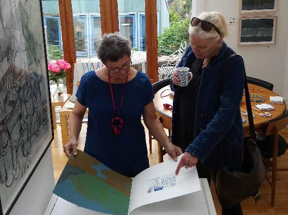 Jan Bickerton shows a visitor the work of fellow artist Rebecca Child, also venue C where five artists are represented.