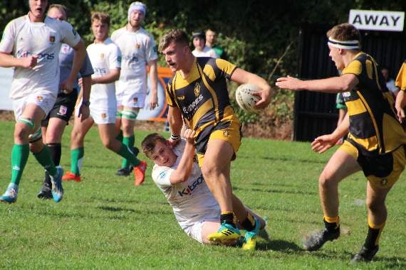 A Crediton ‘Quins player hangs on to the ball despite an attempt by a Newton Abbot player. AQ 6059